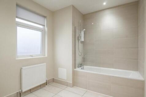 A modern and clean bathroom suite featuring a l...