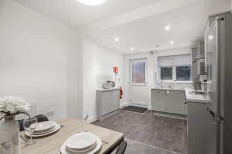 A modern, clean kitchen with ample counter spac...