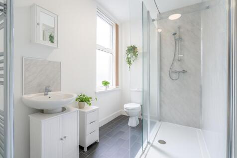 Bright and modern bathroom featuring a large wa...