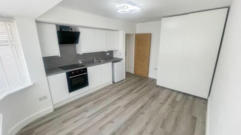 Bright and modern kitchen with sleek white cabi...