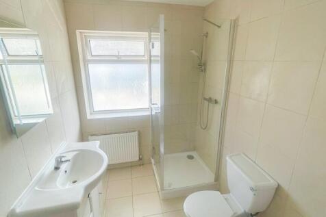 Bright and clean bathroom featuring a modern wa...