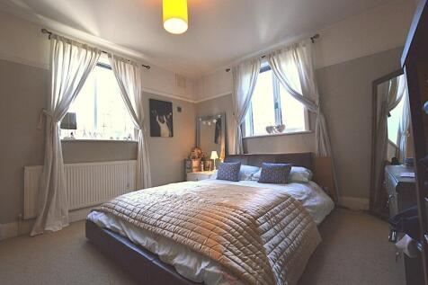 A bright and inviting master bedroom featuring ...
