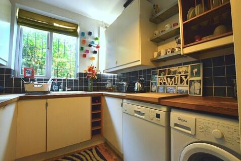 Bright and well-organized kitchen featuring amp...
