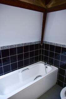 Bright bathroom suite featuring a clean, white ...
