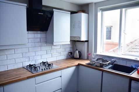 Bright and modern kitchen with sleek white cabi...