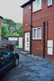A neat front view of a red-brick terraced house...