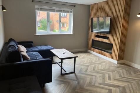 A modern living room featuring a large window p...