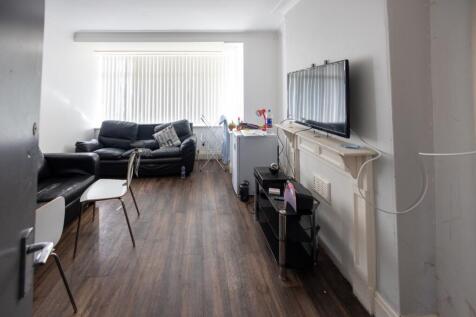 A cozy living room featuring two black leather ...