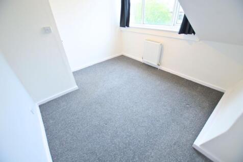 Bright and clean small room with grey carpet fl...