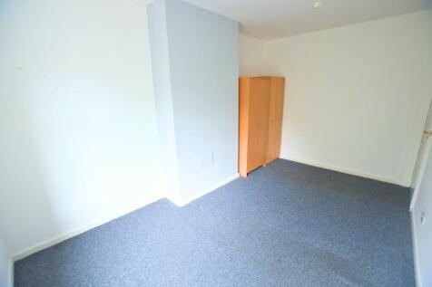 A simple and clean single bedroom featuring neu...