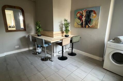 A modern communal workspace featuring a corner ...