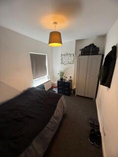 Cozy double bedroom featuring a comfortable bed...