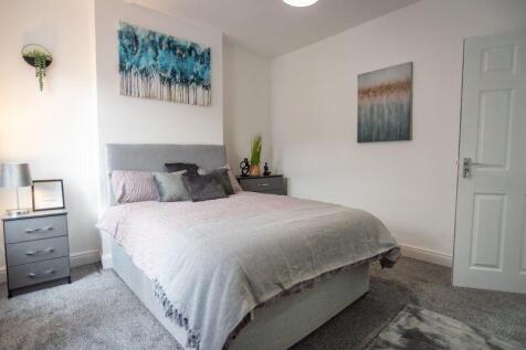 A stylish and cozy master bedroom featuring a c...