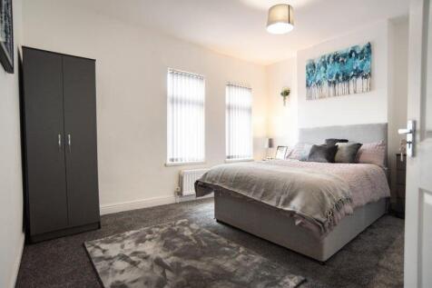 A bright and inviting master bedroom featuring ...