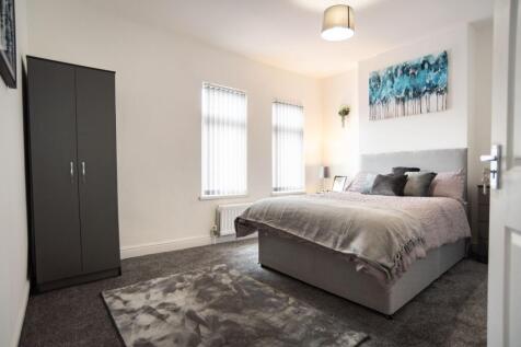 A bright and inviting master bedroom featuring ...