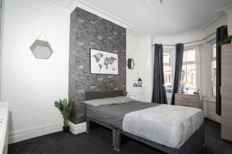 A stylish double bedroom featuring a cozy doubl...