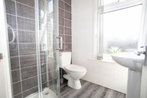 Bright and modern bathroom featuring a spacious...