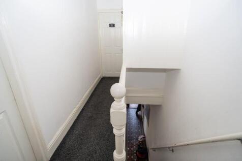 A clean and well-maintained hallway with white ...