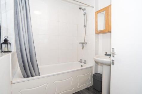 Bright and clean bathroom featuring a classic w...