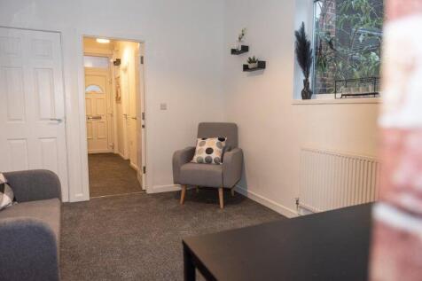 A cozy and well-maintained living room featurin...