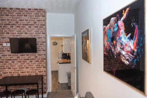 A modern living room with a stylish brick accen...