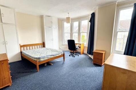 Bright and spacious master bedroom featuring a ...
