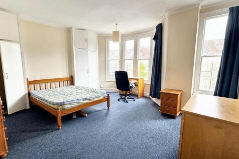 Bright and spacious master bedroom featuring a ...