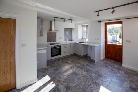 Bright and modern kitchen space featuring styli...