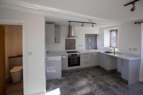 Bright and modern kitchen featuring sleek white...