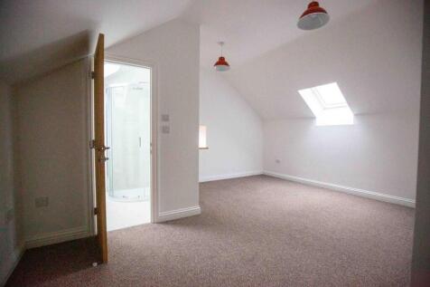 Bright double bedroom with neutral carpet and c...