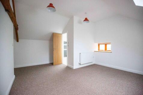 A clean and bright single bedroom featuring whi...