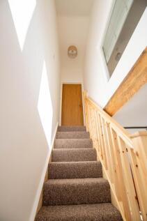 Bright and well-maintained staircase featuring ...