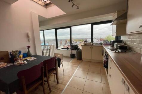 Bright kitchen space featuring a long counterto...