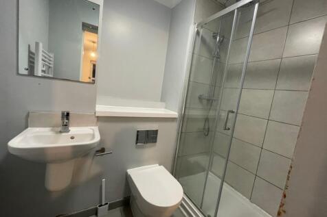 A modern bathroom featuring a clean white sink,...