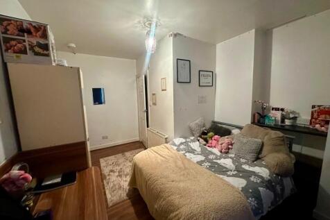 Cozy double bedroom featuring a comfortable bed...