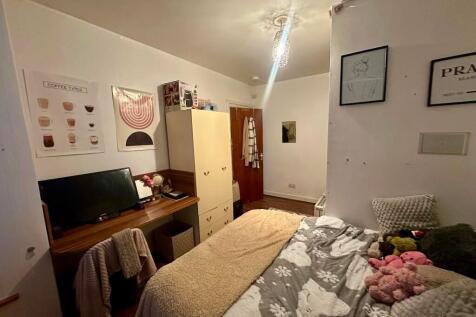 Cozy single bedroom featuring a comfortable bed...