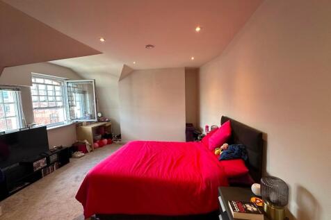 A spacious master bedroom featuring a large dou...