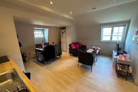 A modern, well-kept living room with ample seat...