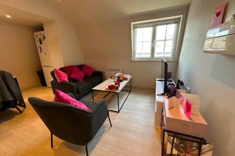 A cozy and well-maintained living room featurin...