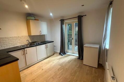 Bright and clean kitchen featuring modern cabin...