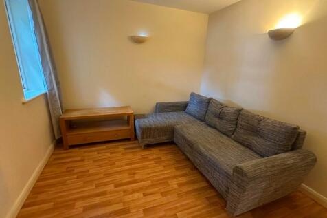 A cozy living room featuring a comfortable grey...