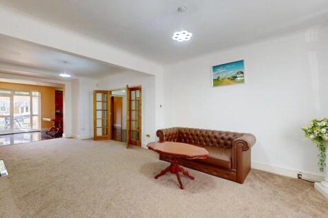 Bright and spacious living room featuring comfo...