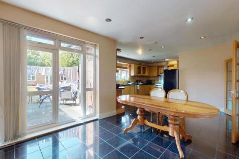 Bright and modern kitchen featuring large windo...