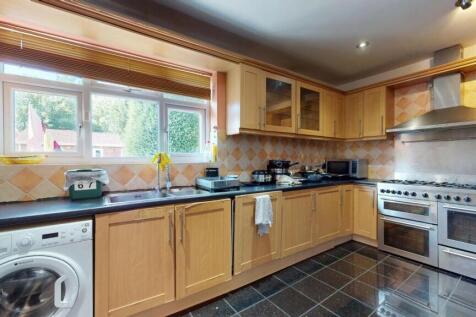 Bright and spacious kitchen featuring ample woo...