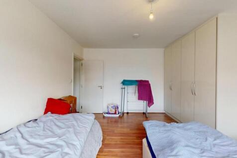 A bright and tidy double bedroom featuring two ...