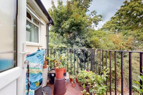 A charming balcony garden space featuring lush ...