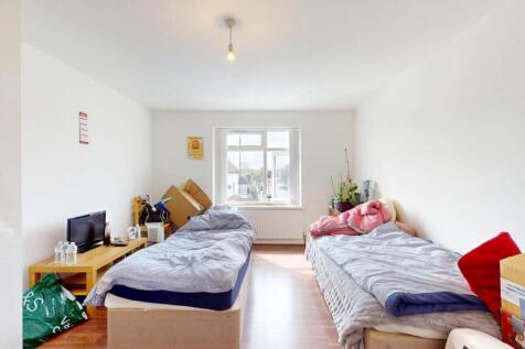 A bright and tidy double bedroom featuring two ...