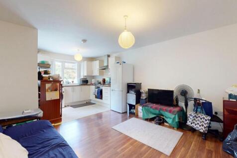 A bright and inviting living room featuring woo...