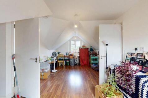 Bright and clean single toilet room with wooden...
