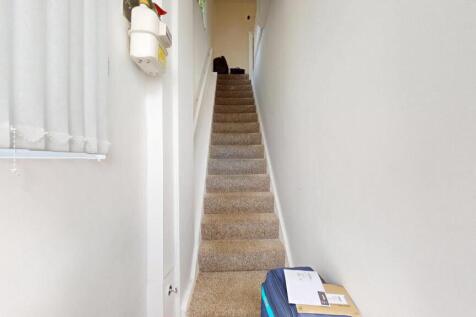 A bright and tidy staircase with carpeted steps...